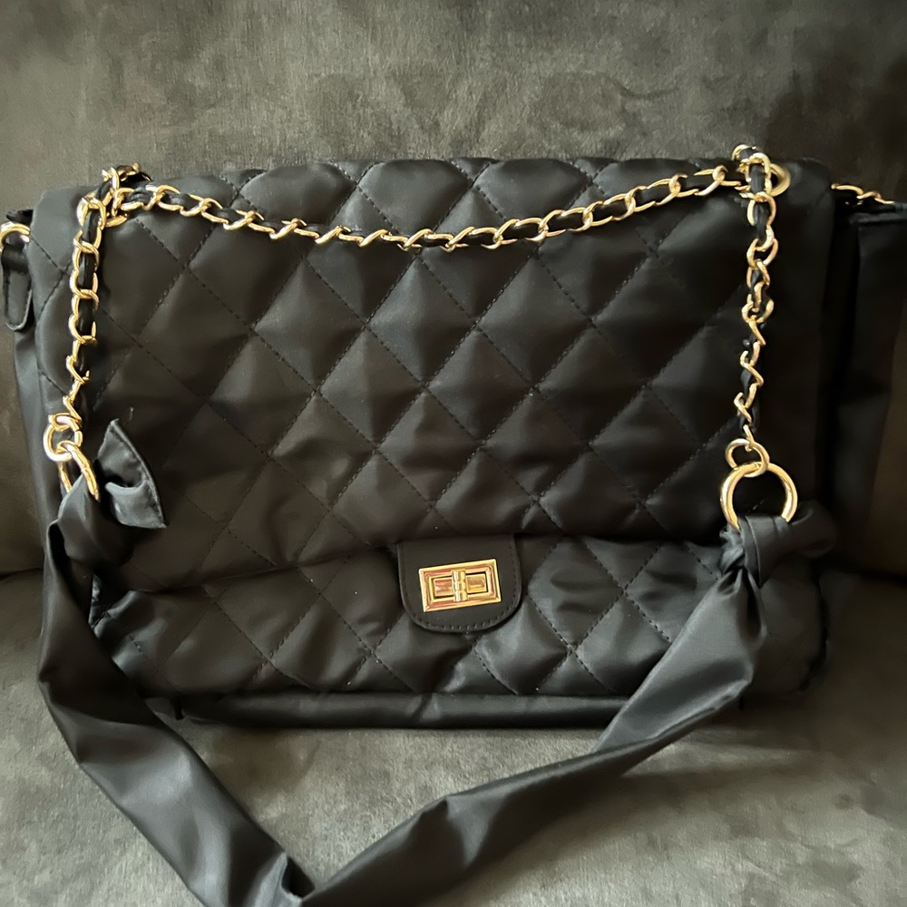 Black nylon quilted shoulder bag.